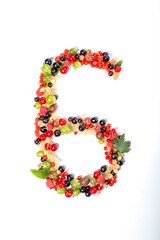 Number six from real natural berries and leaves. Numbers concept made from berries. Summer creative concept.