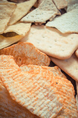 Vintage photo, Heap of salted crisps and cookies, concept of unhealthy food