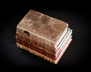 Stack of old books on black background