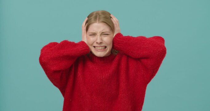 Young woman losing temper and closing her ears to express disapproval, unwilling to listen
