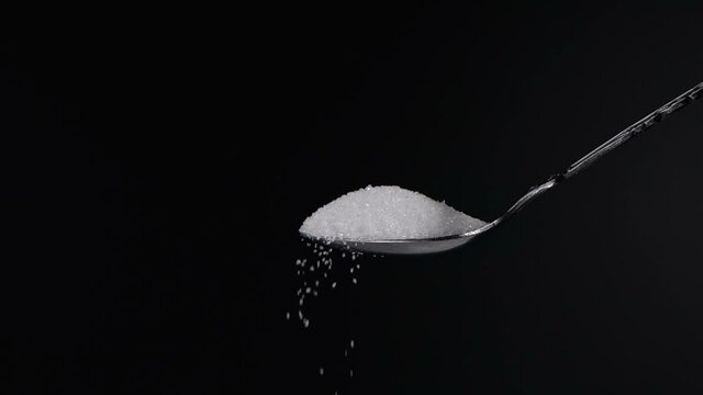  Sugar falling from spoon in slow motion
