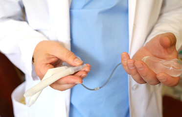 Doctor andrologist holding hydraulic penile prosthesis for falloprosthetics. Penile prosthesis....