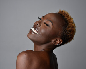 Close up head and shoulders portrait of a pretty young African woman with natural hair. variety of...