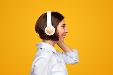 Happy woman enjoying music through headphones