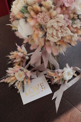 Bridal bouquet of preserved flowers, wedding bouquet. Bouquet of preserved flowers in white and pink shades with silk ribbon.