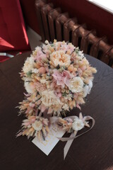 Bridal bouquet of preserved flowers, wedding bouquet. Bouquet of preserved flowers in white and pink shades with silk ribbon.