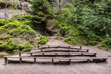 Empty benches of a natural theater in the woods