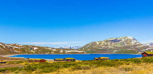 Vavatn lake panorama landscape cottages huts snowy mountains Hemsedal Norway.