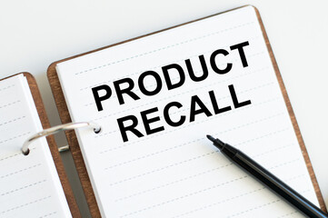 Text Product Recall on an open notebook on a white background.