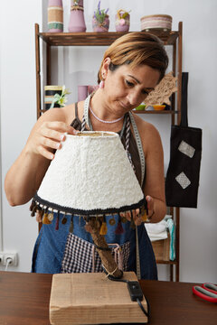 Woman Placing Lampshade To A Handmade Lamp