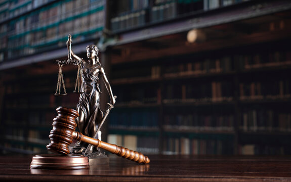 Law theme. Themis statue and judge gavel in the law faculty library.