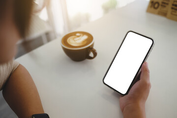 Close up of woman using cell phone,sending massages on the coffee shop with black screen,texting,video calls...