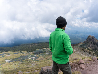 A closeup shot of a Hispanic man staring at the view from the top