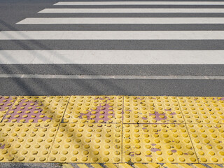 Closeup of a yellow road surface made for blind people
