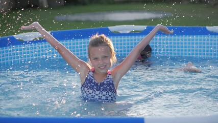happy children swimming in pool. friends splashing playfully having fun swim together on sunny day enjoying cool water on summer vacation.