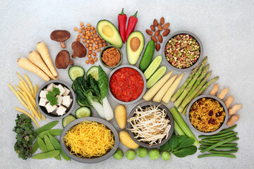 Vegan health food for ethical eating with plant based foods high in antioxidants, protein, minerals, fibre, anthocyanins, vitamins, omega 3, smart carbs and lycopene. Natural healthcare concept.