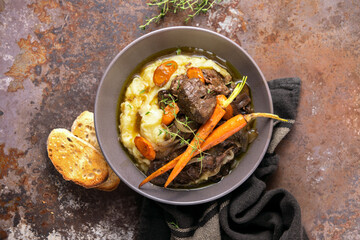 Beef bourguignon served in a rustic manner with smashed potatoes