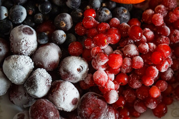 Background from frozen berries of red and black currants, yoshta and cherries.