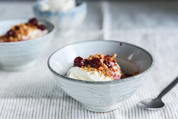 Cherry sauce, cream cheese and feta cream and crumble crust dessert. Homemade Sweet and salty cheesecake. Trifle. Selective focus