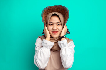 Young modern Muslim woman wearing trendy casual clothes and hijab. Fashionable female girl isolated on blue background.