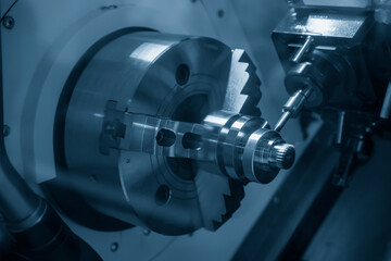 The turn-mill machine cutting the crank shaft part. The hi-technology automotive part manufacturing process by CNC lathe.