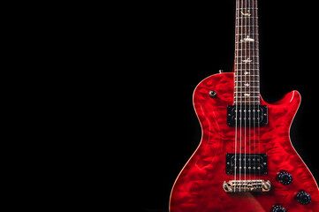 Fototapeta na wymiar Red glossy electric guitar in dark environment