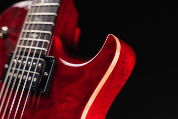 Red glossy electric guitar closeup showing binding of wooden body