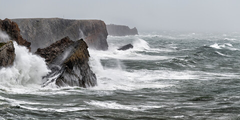 Waves splashing against steep coastal cliffs