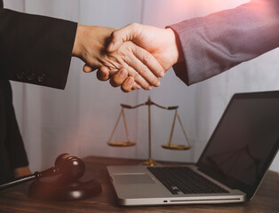 Business and lawyers discussing contract papers with brass scale on desk in office. Law, legal services, advice, justice and law concept picture with film grain effect