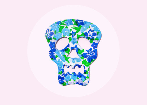 Studio shot of blue skull mask decorated with floral pattern