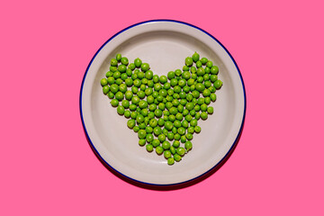 Plate of green peas arranged into shape of heart