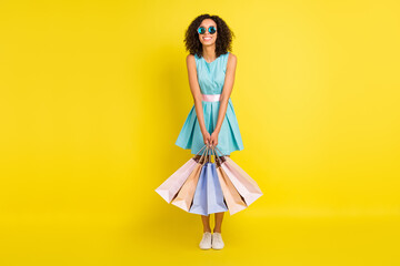 Full length photo of cool wavy hairdo millennial lady hold bags wear blue dress eyewear isolated on...