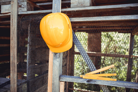 Yellow hardhat hanging on rabbit hutch