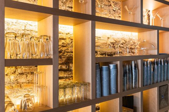 Glasses arranged on shelf in bar