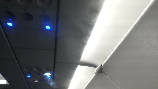 Air conditioing outlets of an aeroplane are releasing cool air to keep temparature down inside flight.