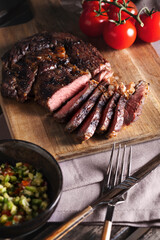Medium-rare rib eye steak with vegetable sauce