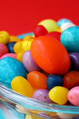 Fototapeta na wymiar colorful easter eggs and candies in glass bowl