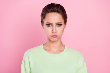 Photo of young girl pouted cheeks hold breath unhappy upset moody offended isolated over pink color...