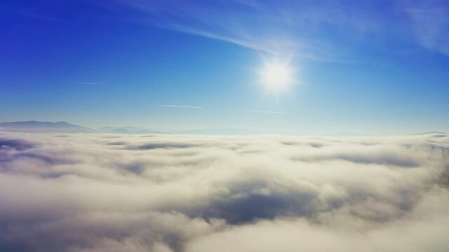 Wonderful view of extraordinary cloudy valley and bright orange sunset