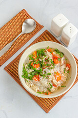 A Bowl of Chicken Noodle Soup on White Background Directly Above Vertical Photo
