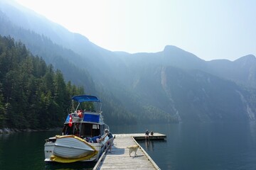 An incredible view of princess louisa inlet from the dock with one family and their boat tied up,...