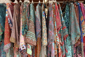Ethnic tunics hung on hangers in a shop in Ibiza.