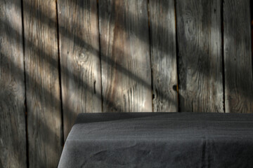 Wooden wall with shadows and table background of free space 