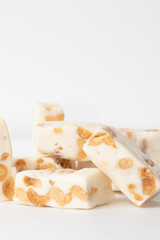 Bar of nougat isolated on white background.