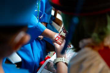 Face or body paint focusing on the hand at the graduation ceremony of the child