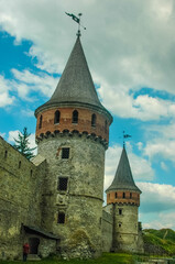 Fototapeta na wymiar Tower of Kamyanets-Podilsky fortress on a background of cloudy sky