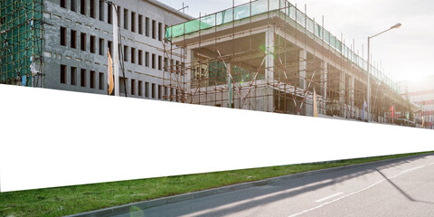 Long blank hoarding with space for advert mockup on construction site © Bonsales