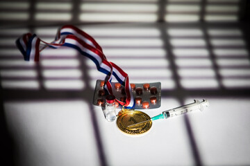 Champion gold medal, doping substance syringe, pill tablet and prohibited substance vial with...