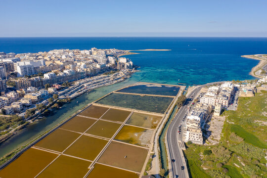 Malta, Northern District, Saint Pauls Bay, Aerial view of coastal town and salt flats of�Salina Nature Reserve