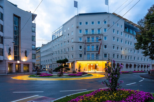 Austria, Salzburg State, Salzburg, Empty traffic circle at dawn with luxury hotel in background